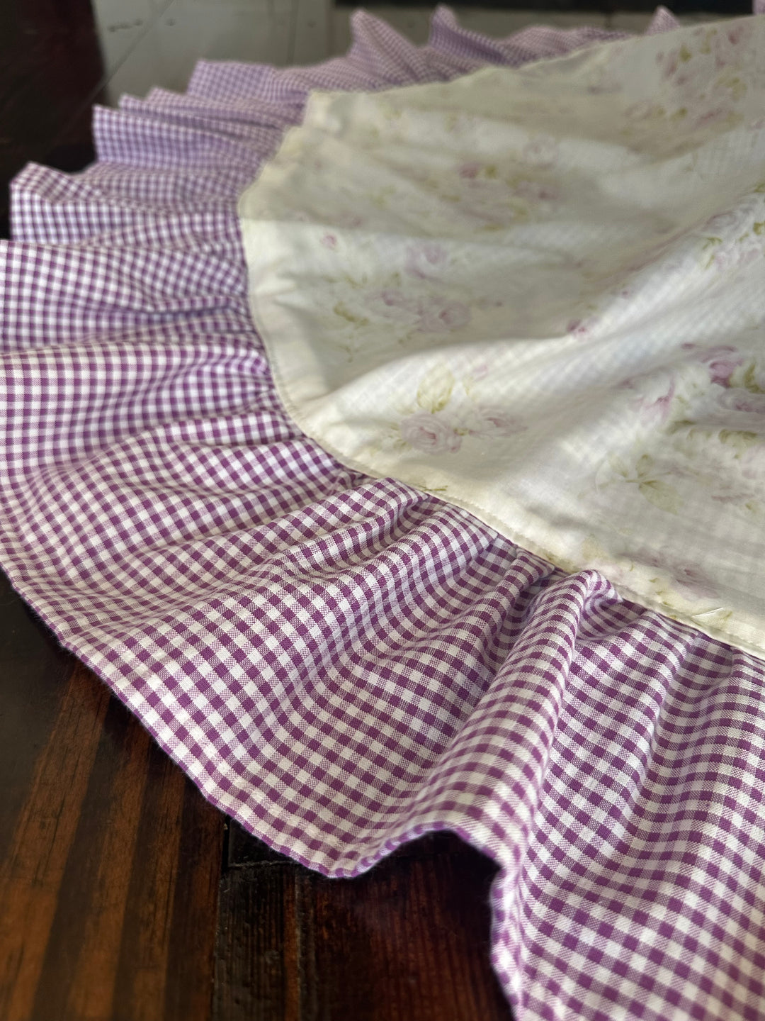 Gathered lavender gingham ruffle in soft folds beside the cream floral body of the tree skirt