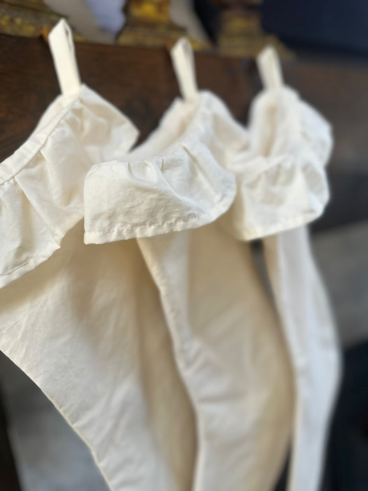 Side view down the row of ivory stockings, the soft gathered ruffles stacked one behind another