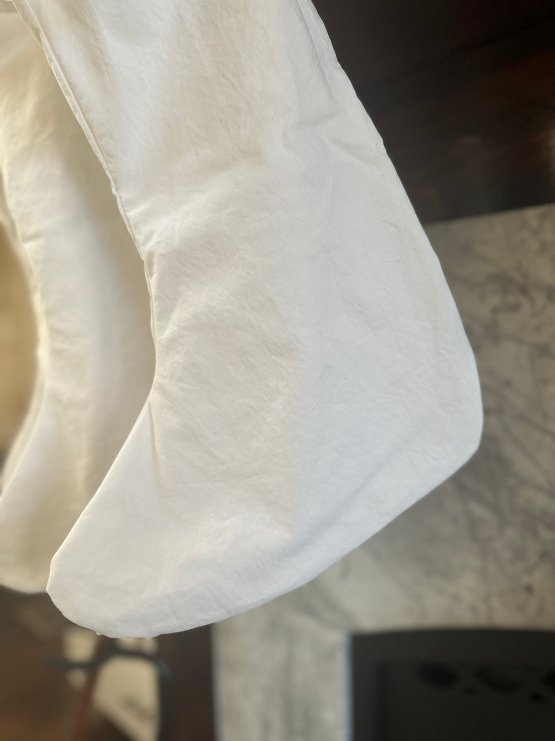 Detail of the curved toe on a white washed cotton Christmas stocking