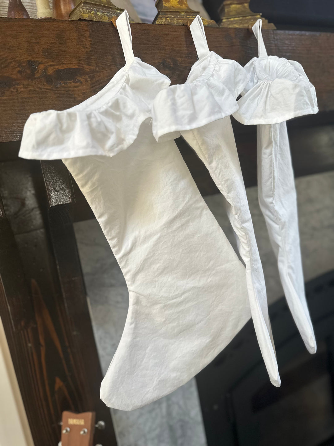 Side view down the line of white stockings, the gathered ruffles stacked one behind another