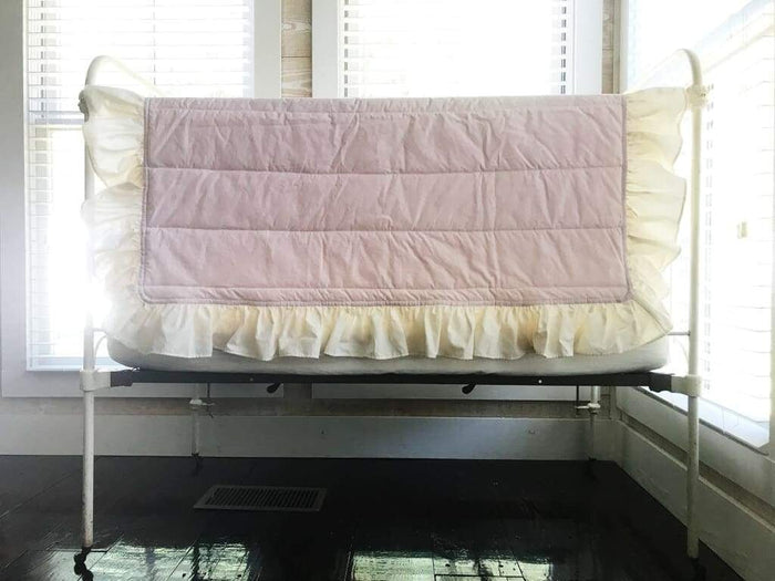 Baby pink handmade baby quilt with an ivory ruffle border