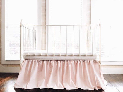 Baby pink farmhouse crib skirt, gathered on all four sides with a 20-inch drop