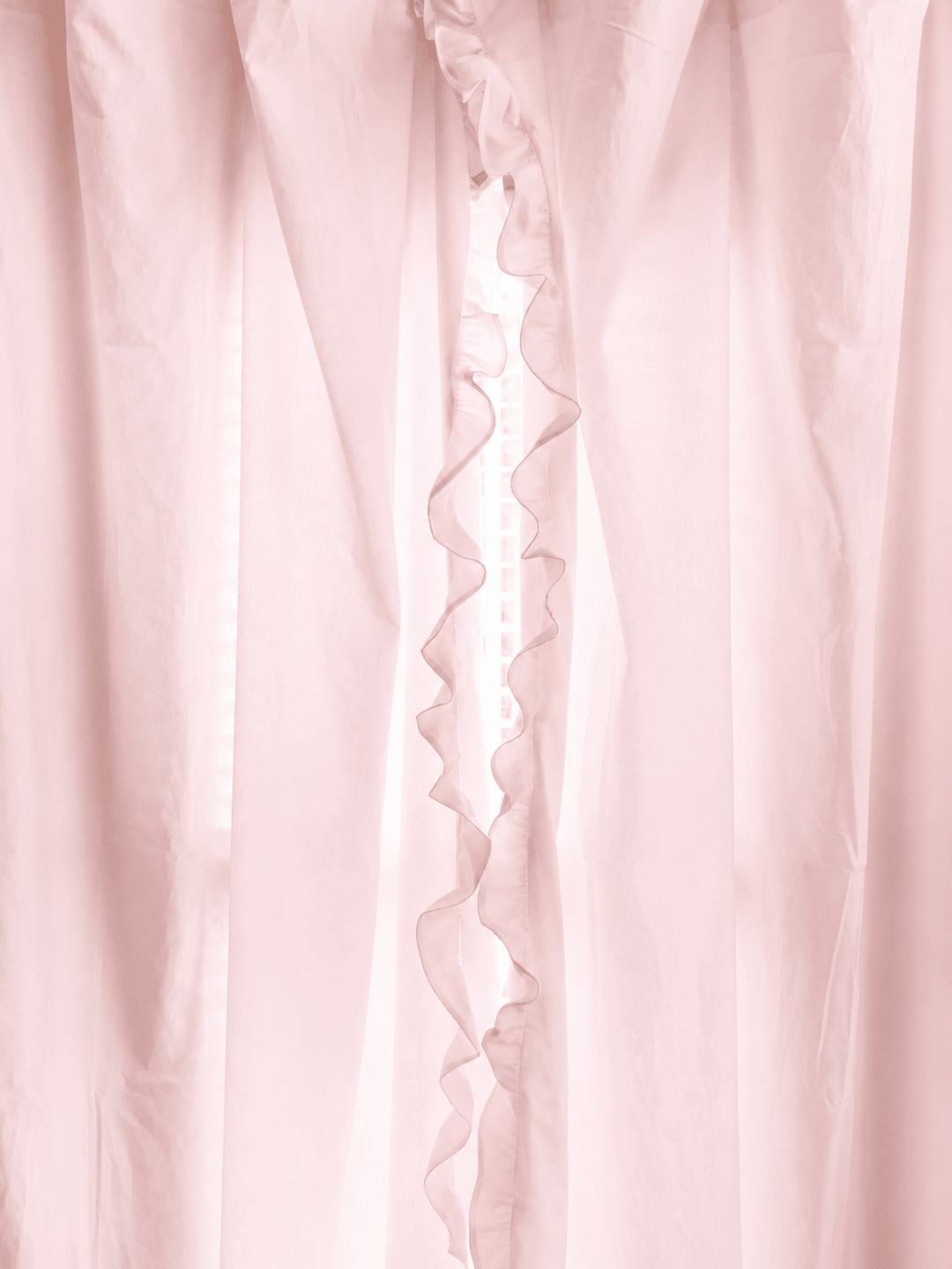 Baby pink ruffled curtain panels parted at the center, the ruffle running the full length of the leading edge - High Cotton Textile