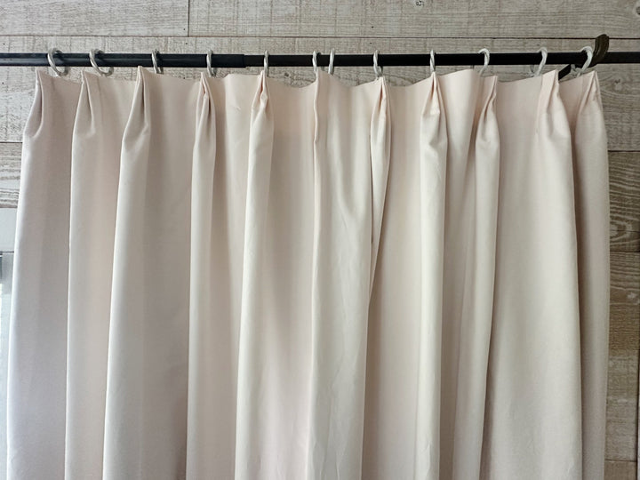 Straight-on view across a pleated Ballet Slipper Pink panel hanging from white rings