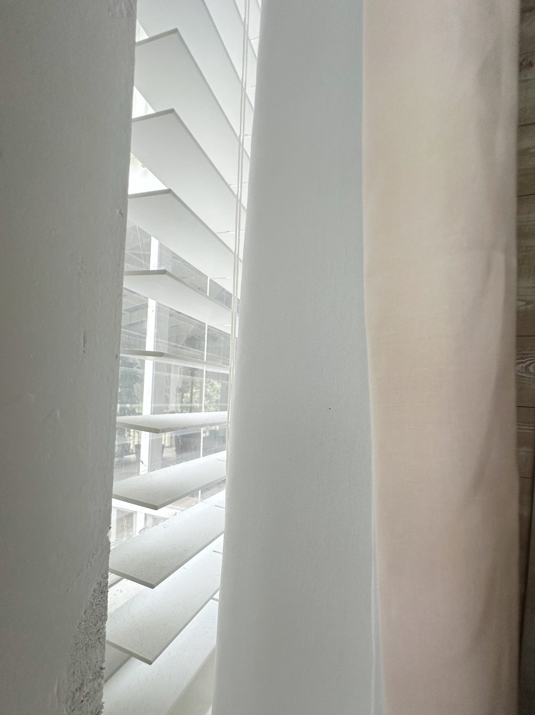 Edge of a Ballet Slipper Pink panel beside its white lined back, with window blinds behind