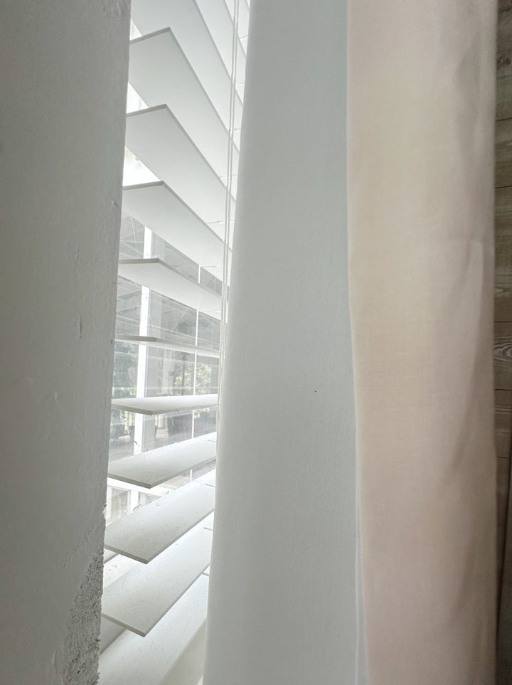 Edge of a Ballet Slipper Pink panel beside its white lined back, with window blinds behind