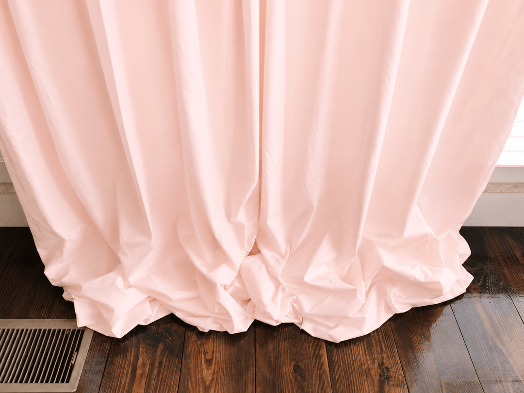 Close view of the Ballet Slipper Pink curtain hem gathered on the floor, showing the weight of the lined cotton - High Cotton Textile