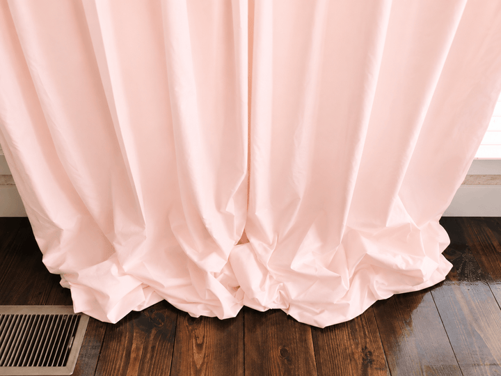 Close view of the Ballet Slipper Pink curtain hem gathered on the floor, showing the weight of the lined cotton - High Cotton Textile
