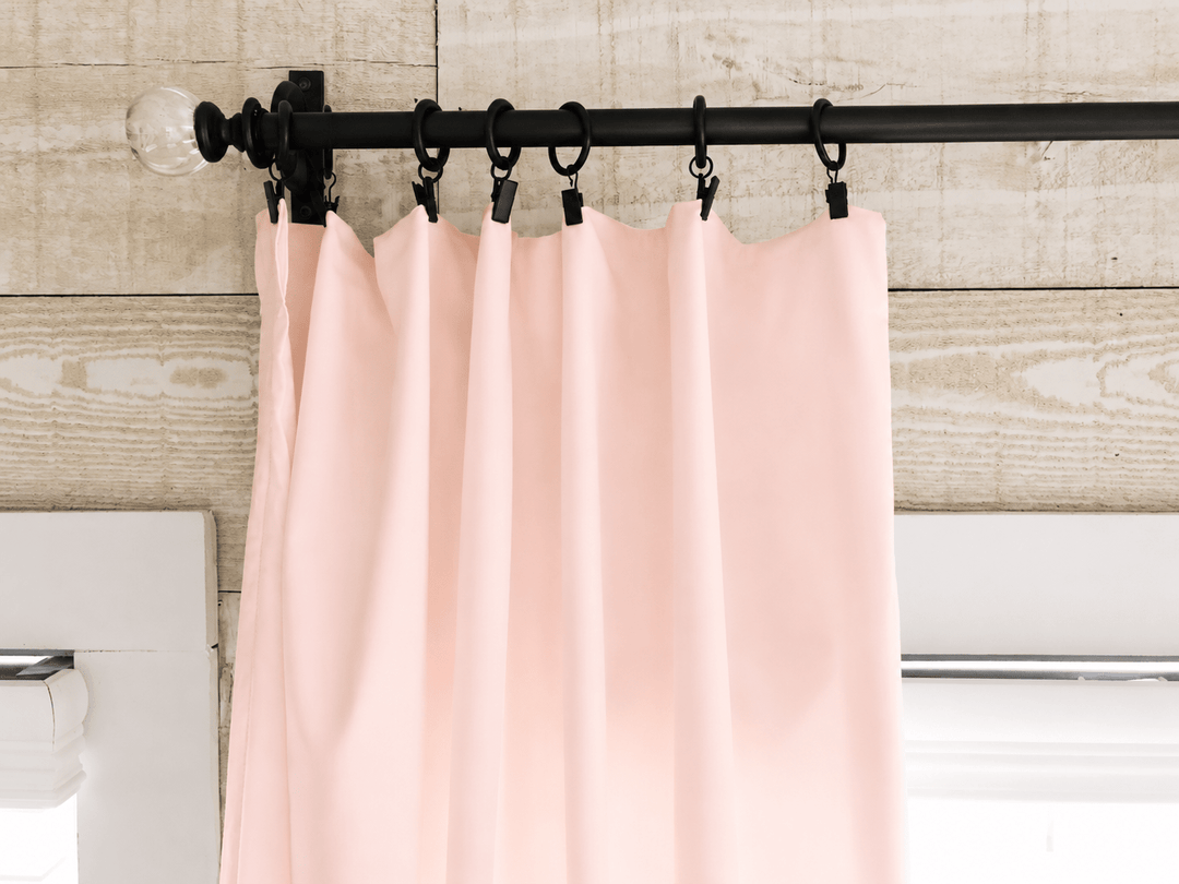 Ballet Slipper Pink farmhouse curtain panel hanging in soft folds from a black rod and clip rings - High Cotton Textile