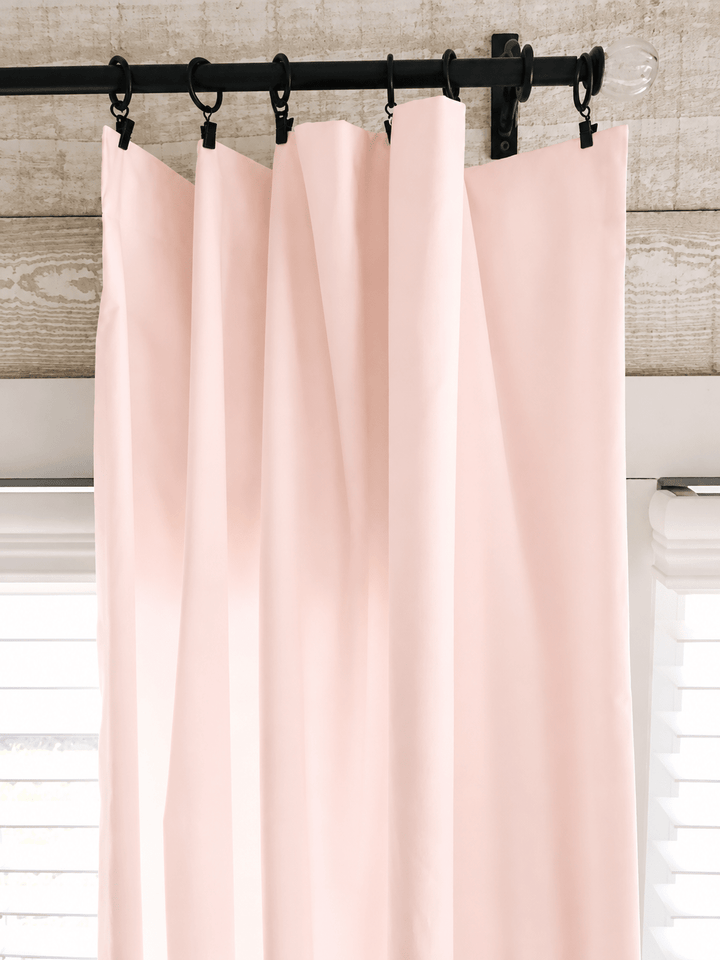 Close view of the Ballet Slipper Pink curtain heading on iron clip rings, showing the clean flat edge with no ruffle - High Cotton Textile