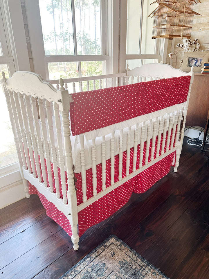 Angled view of the dotted rail cover and the pleated dotted skirt below the spindles