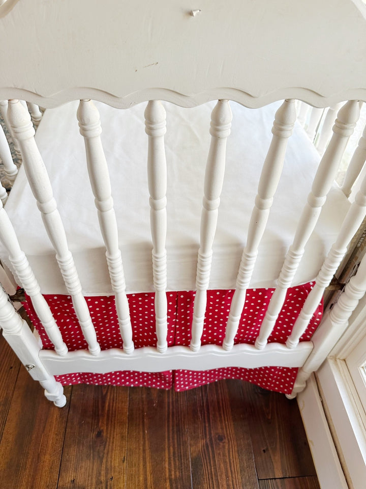 Close on the skirt's inverted center pleat where the two dotted panels meet below the scalloped end panel