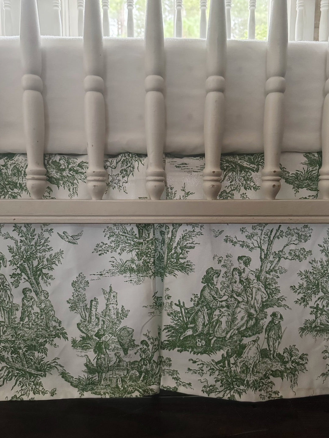 Close view of the cypress green rail cover showing white cording trim and white tiny ties