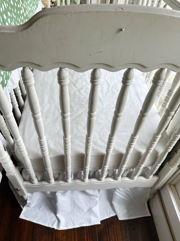 Foot of the crib with the white farmhouse skirt at a 20-inch drop