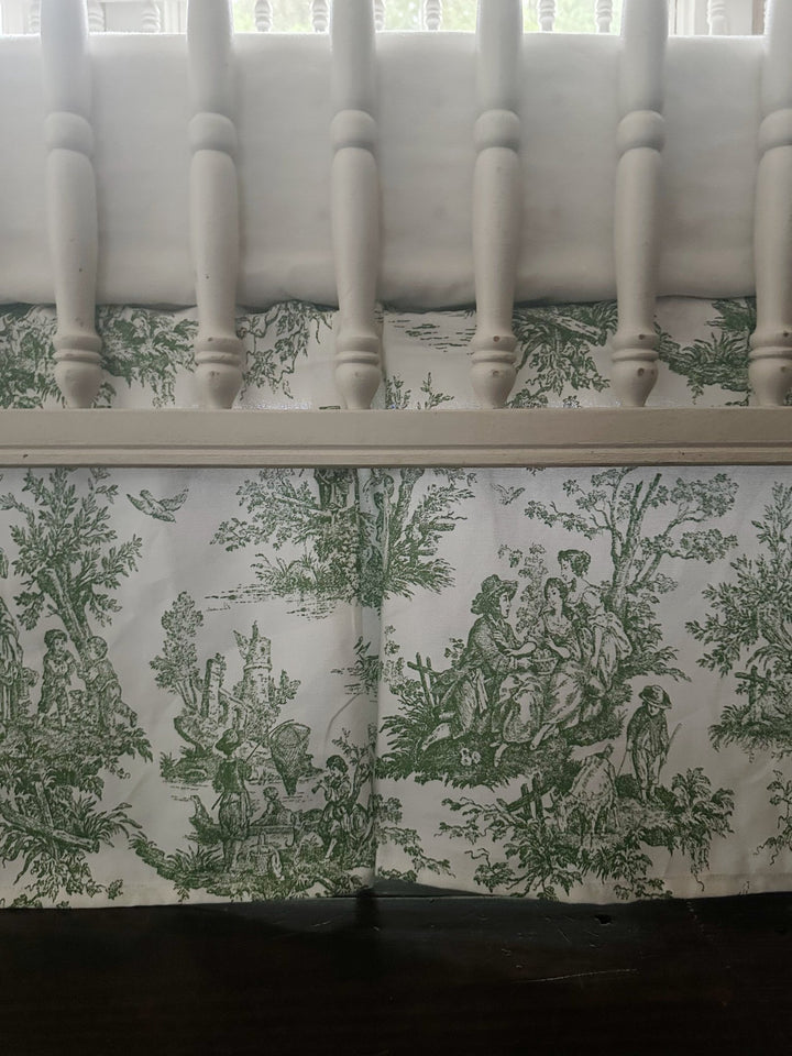 Close view of the green toile skirt showing the pastoral scene and the crisp box pleat