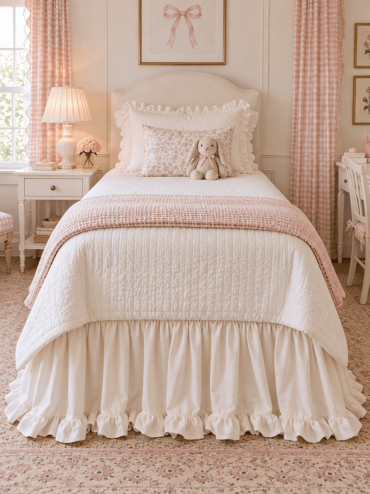 Straight on view of an ivory ruffled twin bed skirt across the full width of the bed - High Cotton Textile