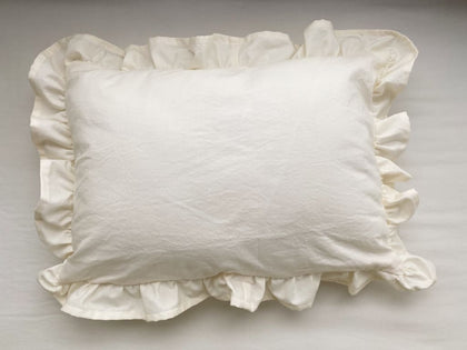 Ivory ruffled crib pillow in washed cotton