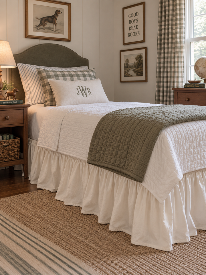 Wide view of a boy's bedroom with an ivory farmhouse twin bed skirt and green gingham curtains - High Cotton Textile