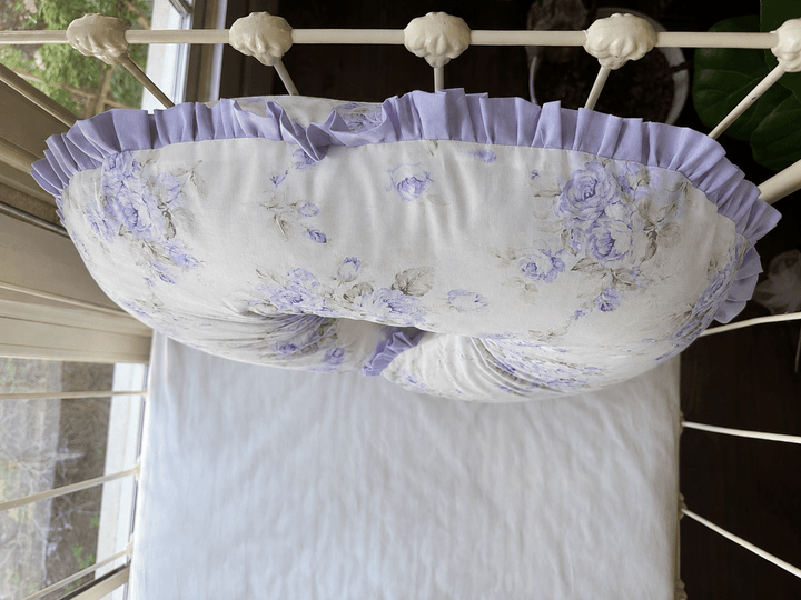 Lavender Shabby Chic Floral Boppy pillow cover shown on a white iron crib, handmade in Alabama by High Cotton Textile