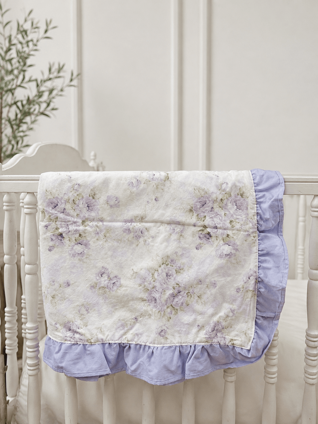Lavender Shabby Chic Floral ruffled crib blanket with lavender ruffle trim draped over a white crib rail, handmade in Alabama