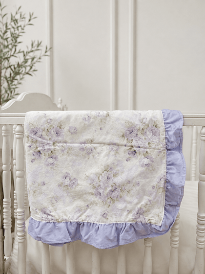Lavender Shabby Chic Floral ruffled crib blanket with lavender ruffle trim draped over a white crib rail, handmade in Alabama