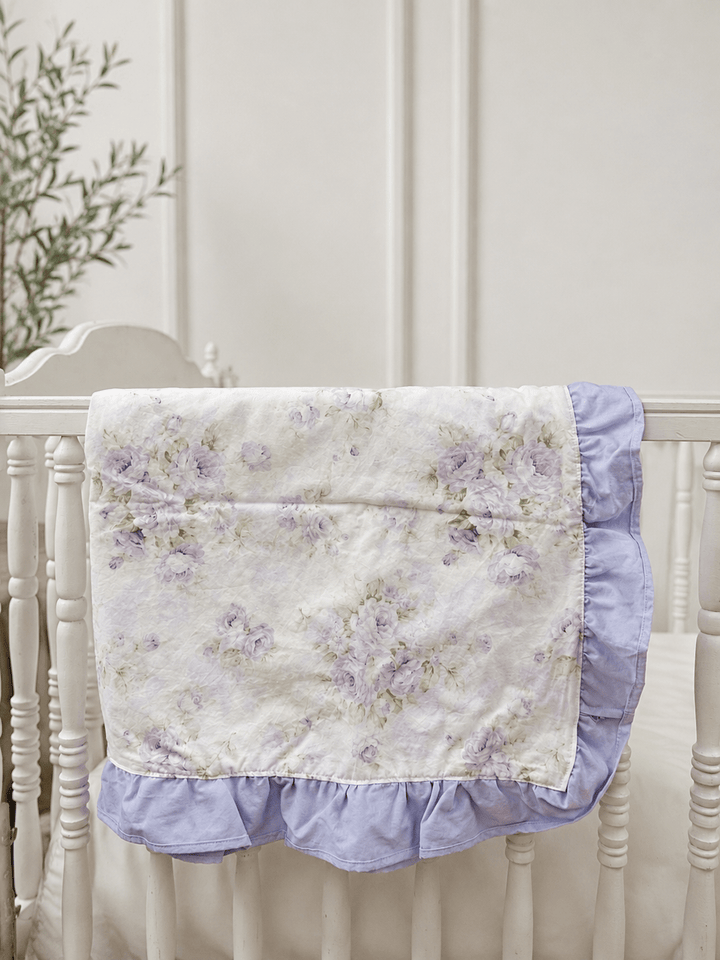 Lavender Shabby Chic Floral ruffled crib blanket with lavender ruffle trim draped over a white crib rail, handmade in Alabama