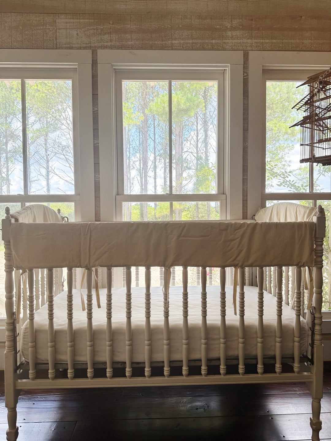 Gender neutral Natural crib rail cover set on a white heirloom crib in a bright nursery