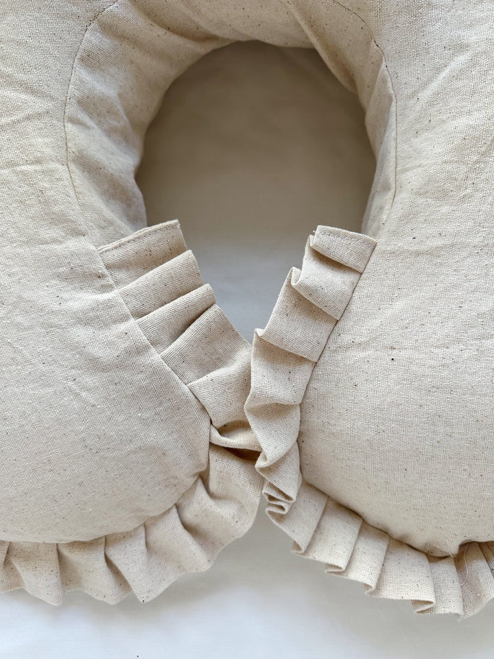 Pleated osnaburg ruffle wrapping both tips of the Natural Osnaburg Boppy cover where they meet