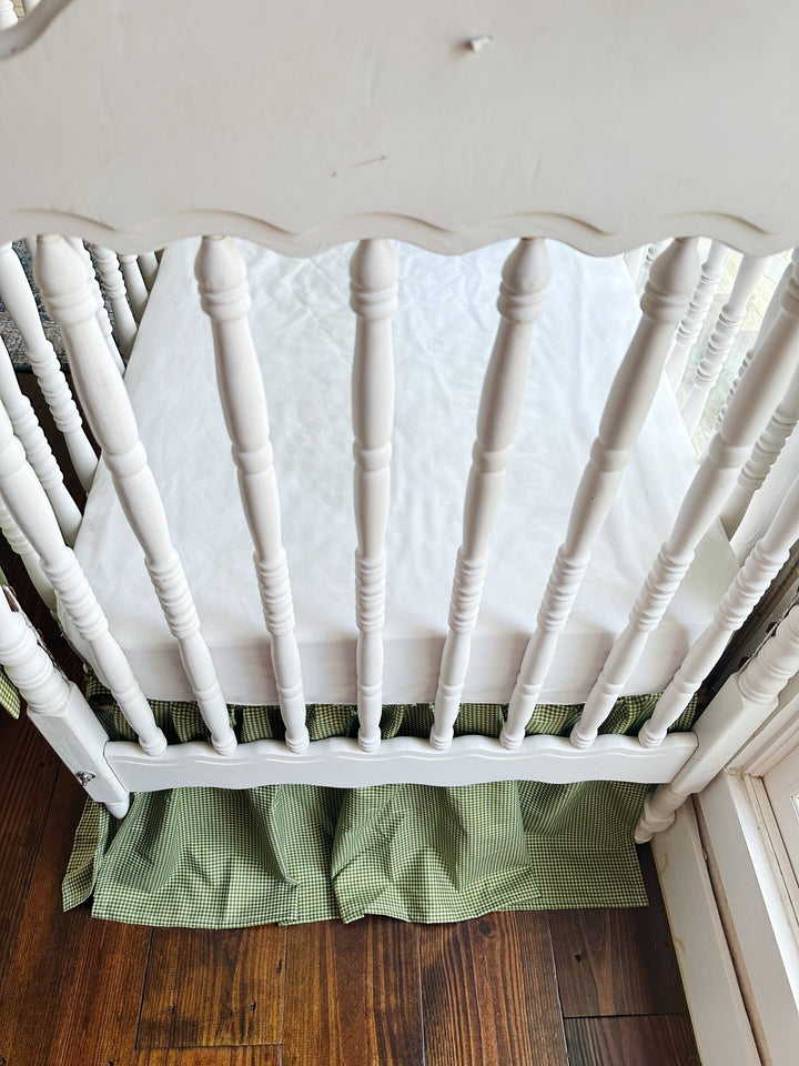 White spindle crib end with the green gingham gathered farmhouse crib skirt