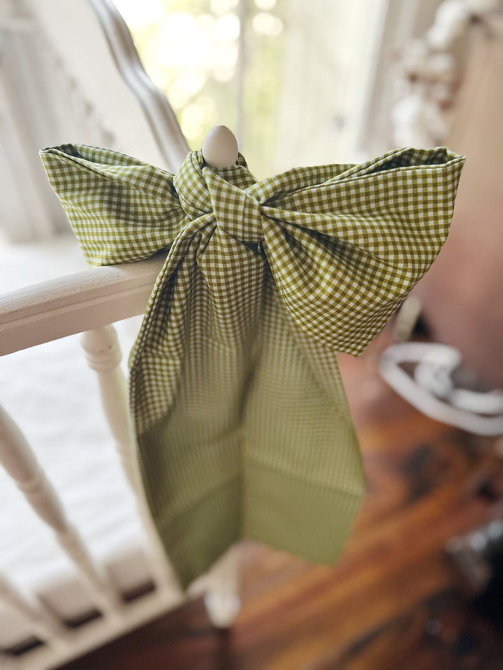 Large pine green gingham crib bow sash tied to a white crib rail
