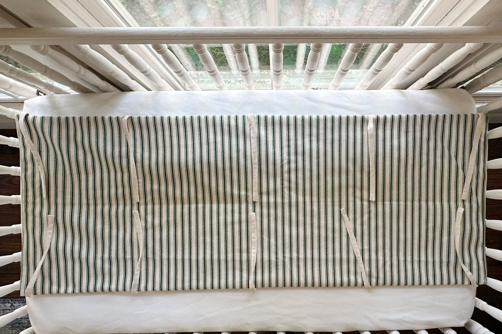 The rail cover seen from above, showing the full flat panel and the natural osnaburg ties along both edges