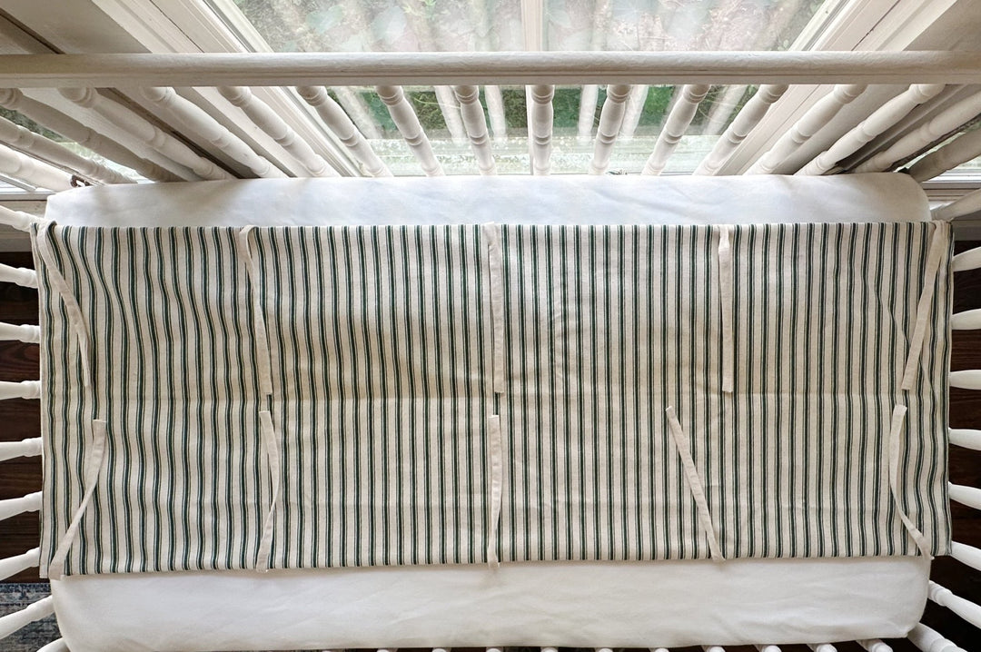 The rail cover seen from above, showing the full flat panel and the natural osnaburg ties along both edges
