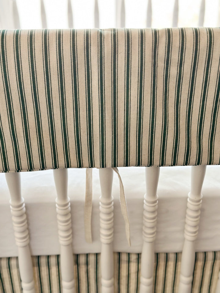 Close view of the woven green ticking stripe and a single narrow natural osnaburg tie