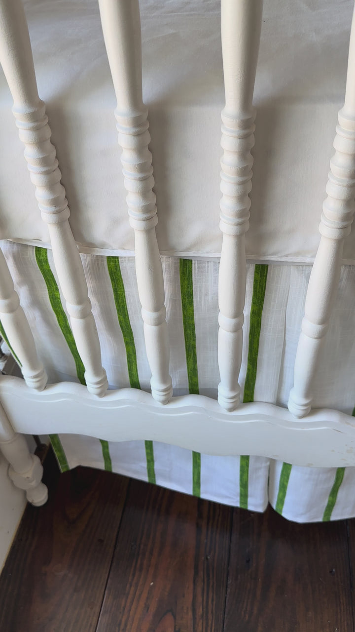 Walking video of the cypress green and white striped tailored crib skirt on a vintage white spindle crib
