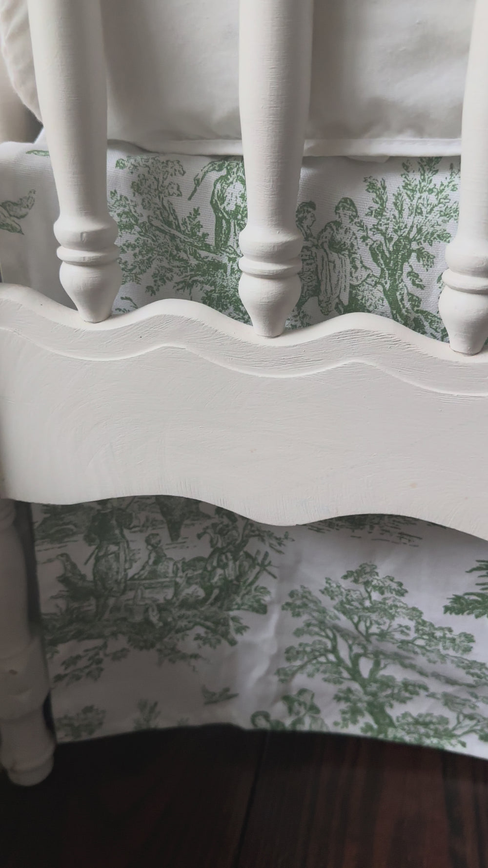 Video of a white and green toile crib bedding set by High Cotton Textile on a white crib