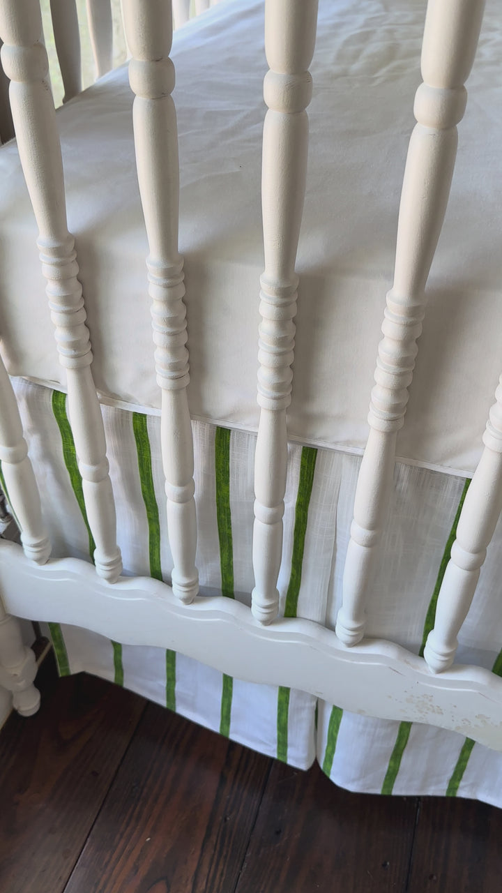 Walking video of the green striped crib rail cover, matching striped tailored skirt and cypress green sashes in the nursery