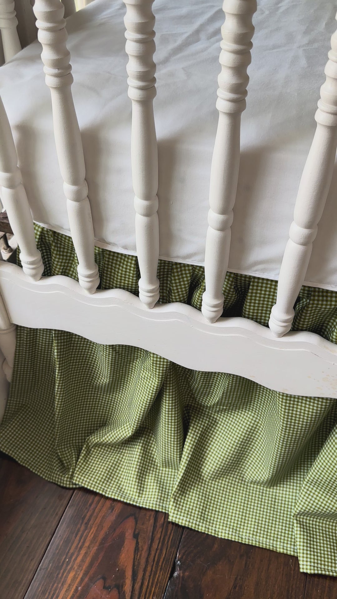 Video of the pine green gingham crib rail cover, farmhouse skirt and bows on a white crib.