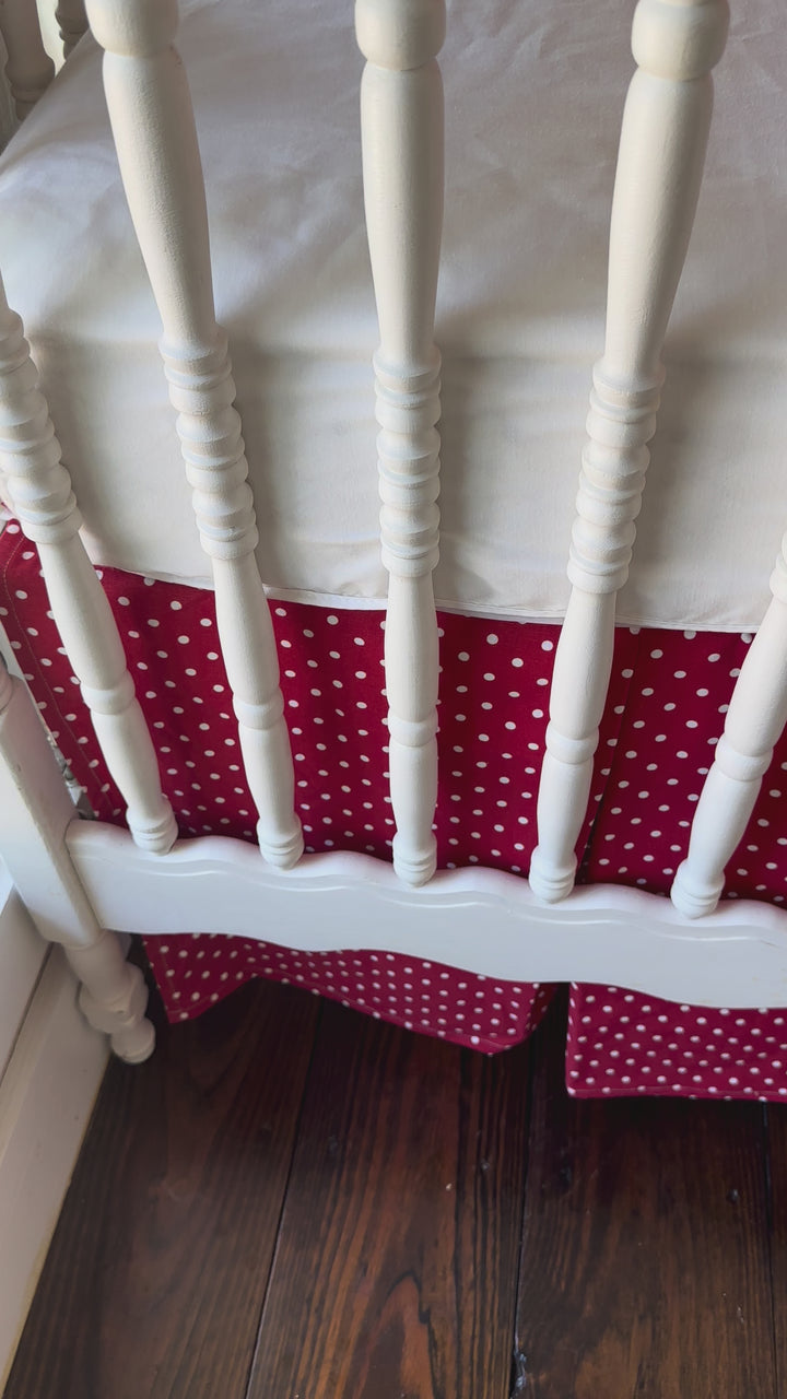 Walking video of the red polka dot ruffled rail cover and matching dotted tailored crib skirt