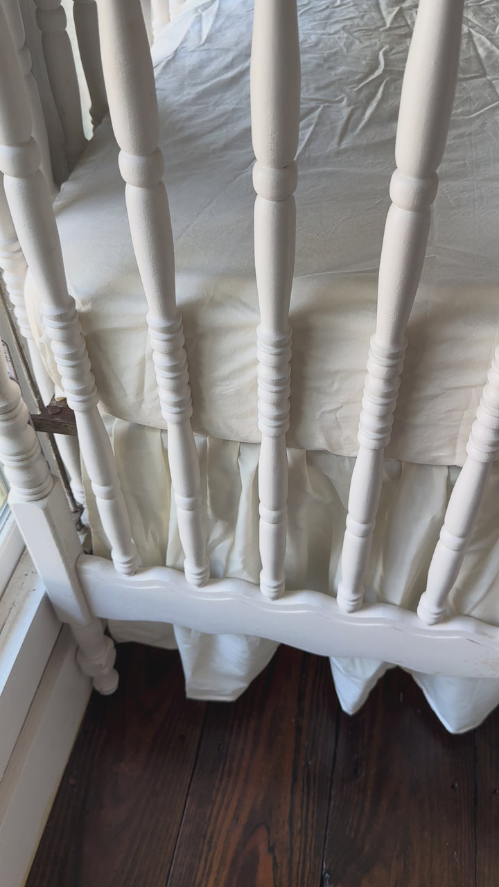 Walking video of the Ivory Farmhouse Crib Skirt & 2 Bows Set in the nursery