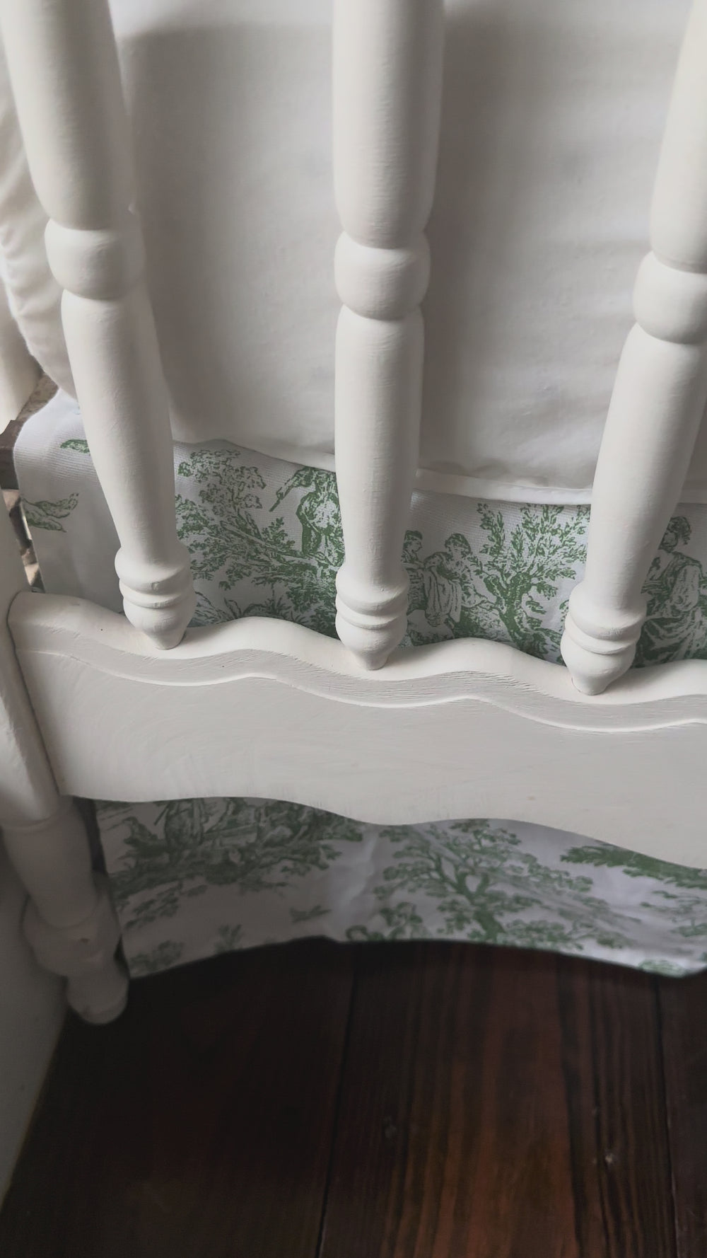 Walking video of the white tailored crib rail cover and green toile crib skirt in the nursery
