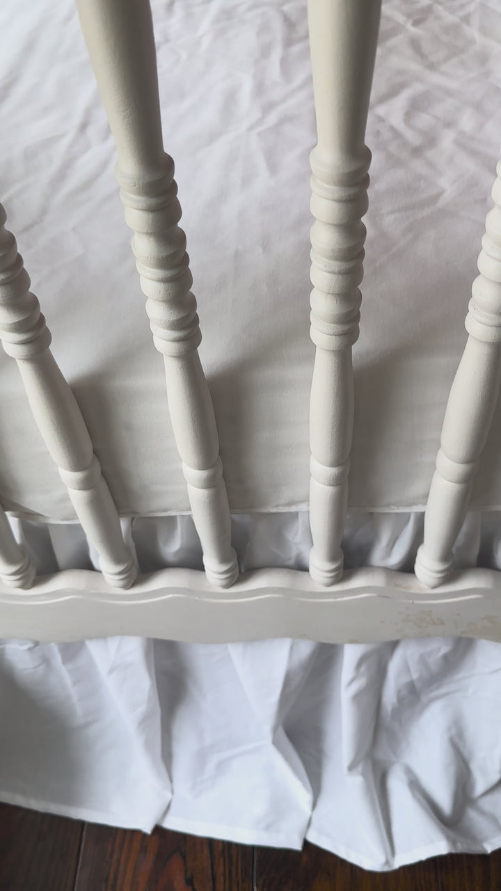Walking video of the red and white polka dot crib rail cover, white farmhouse skirt and white bows in the nursery