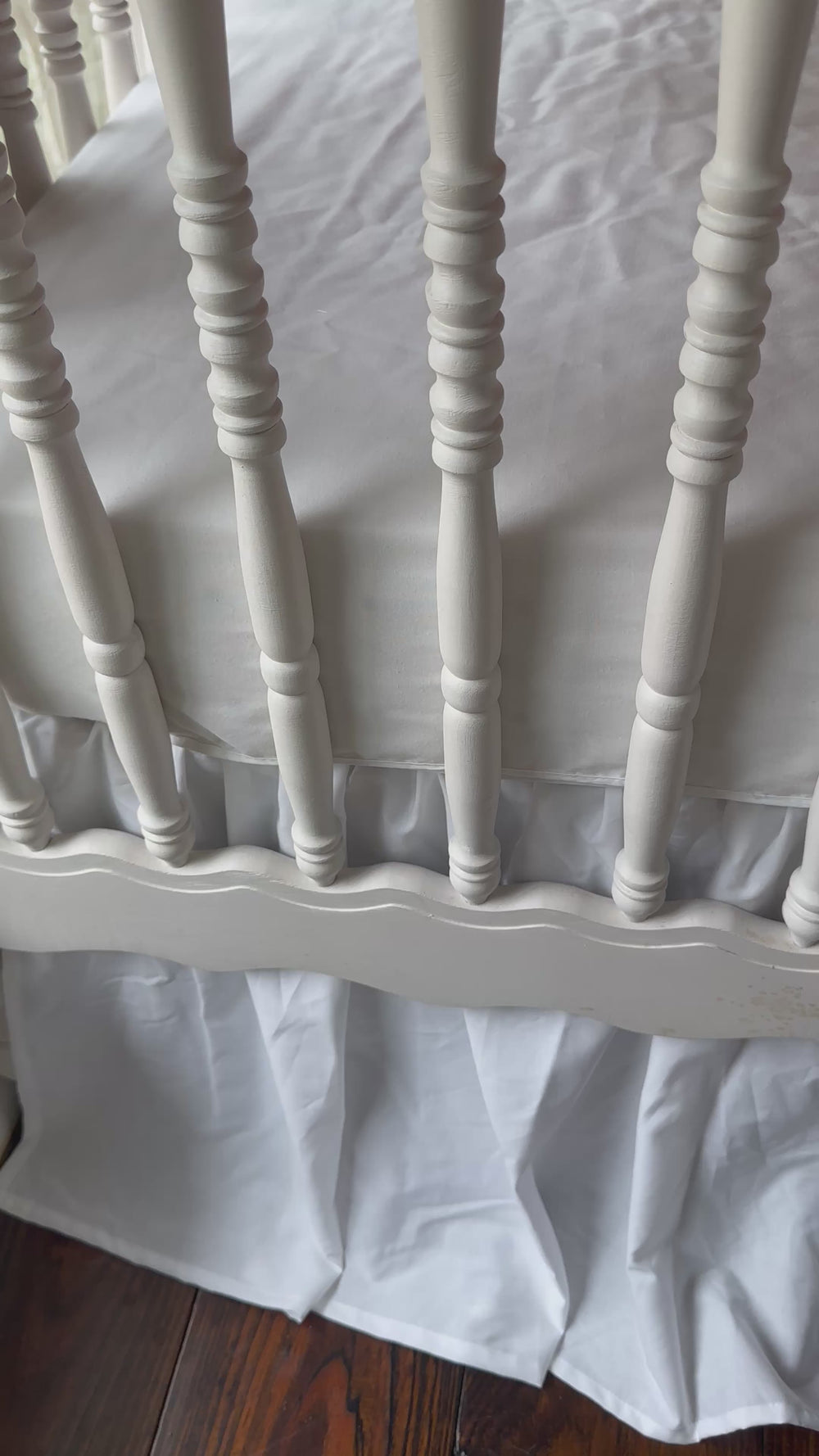 Walking video of the red ruffled crib rail cover, white farmhouse skirt and white bows in the nursery