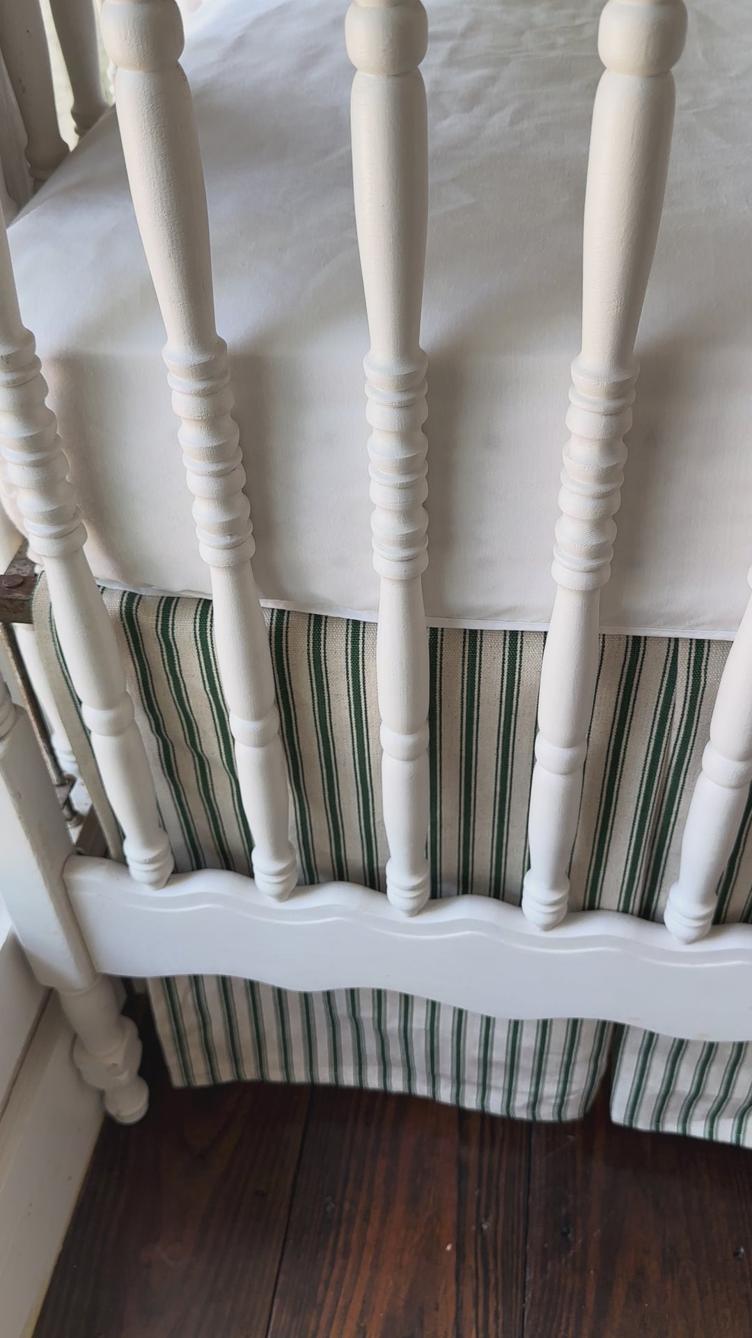 Walking video of the pine green ticking simple crib rail cover and matching tailored ticking crib skirt