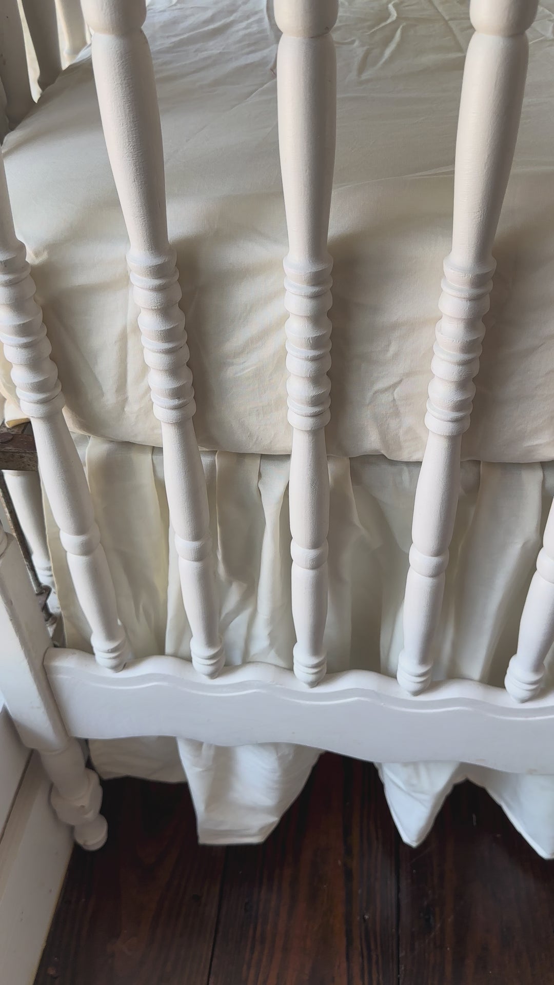 Walking video of the Ivory Ruffled Crib Rail Cover, Farmhouse Skirt & 2 Bows Set in the nursery