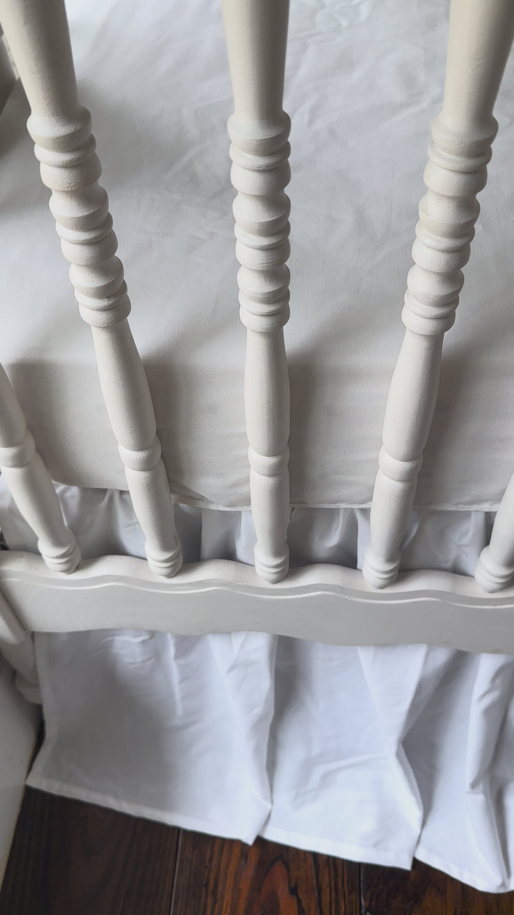 Walking video of the green and white striped rail cover and white farmhouse crib skirt in the nursery