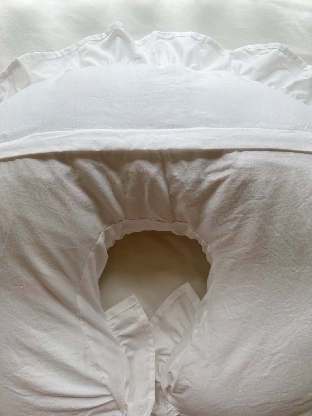 Gathered ruffle trim detail on a white cotton Boppy pillow cover