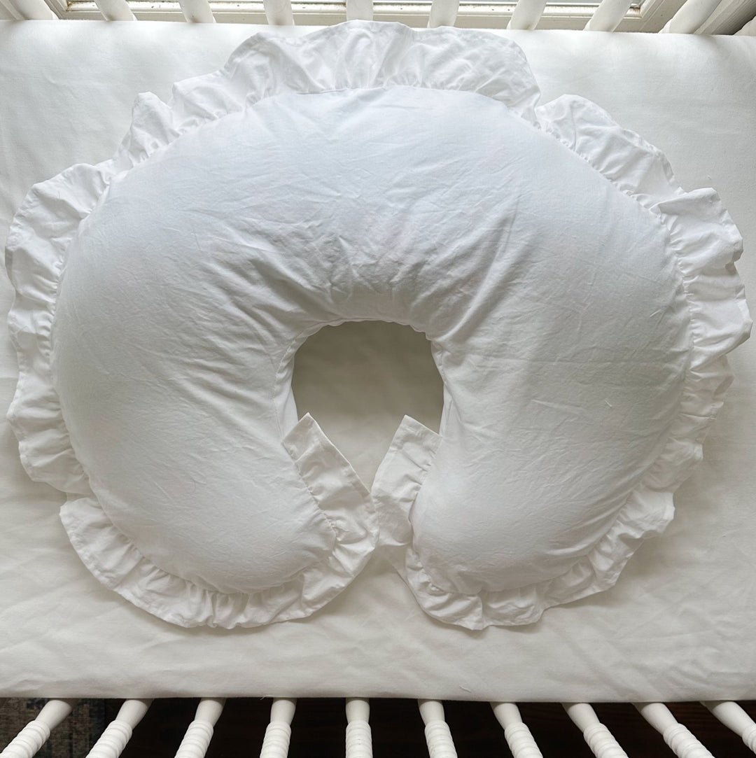 White ruffled Boppy pillow cover in a white crib — High Cotton Textile