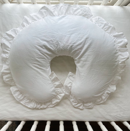 White ruffled Boppy pillow cover in a white crib — High Cotton Textile