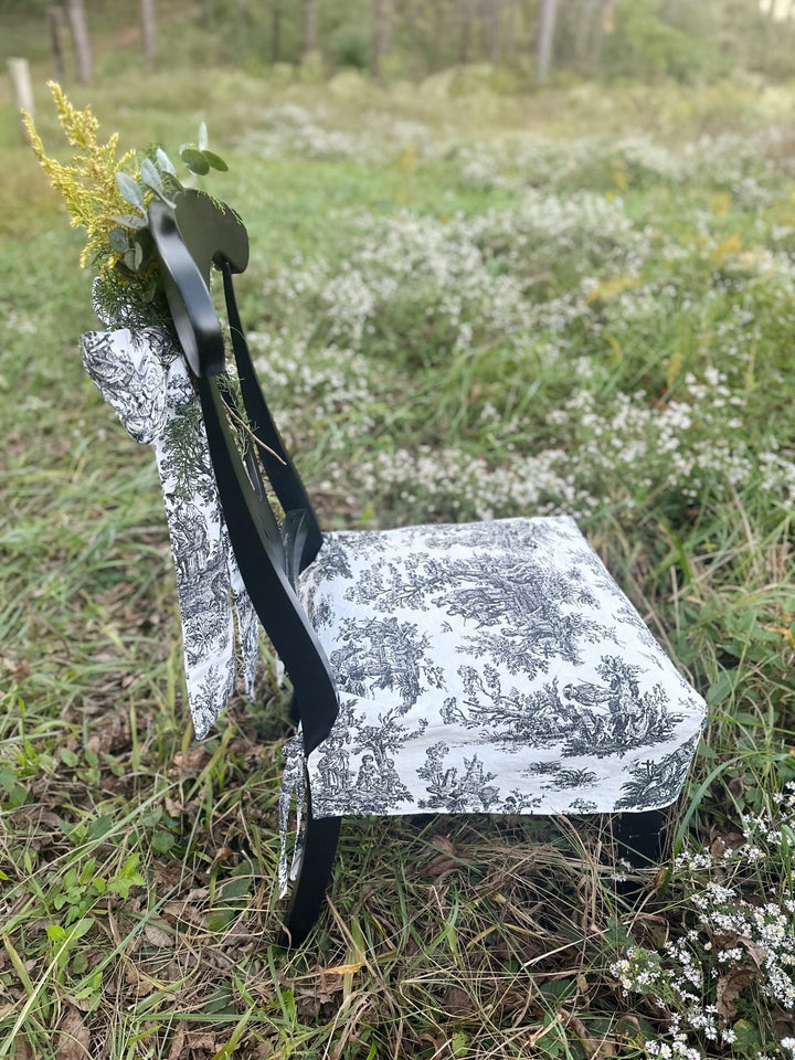 Side view of the toile chair slipcover showing the crisp boxed seat and short tailored skirt