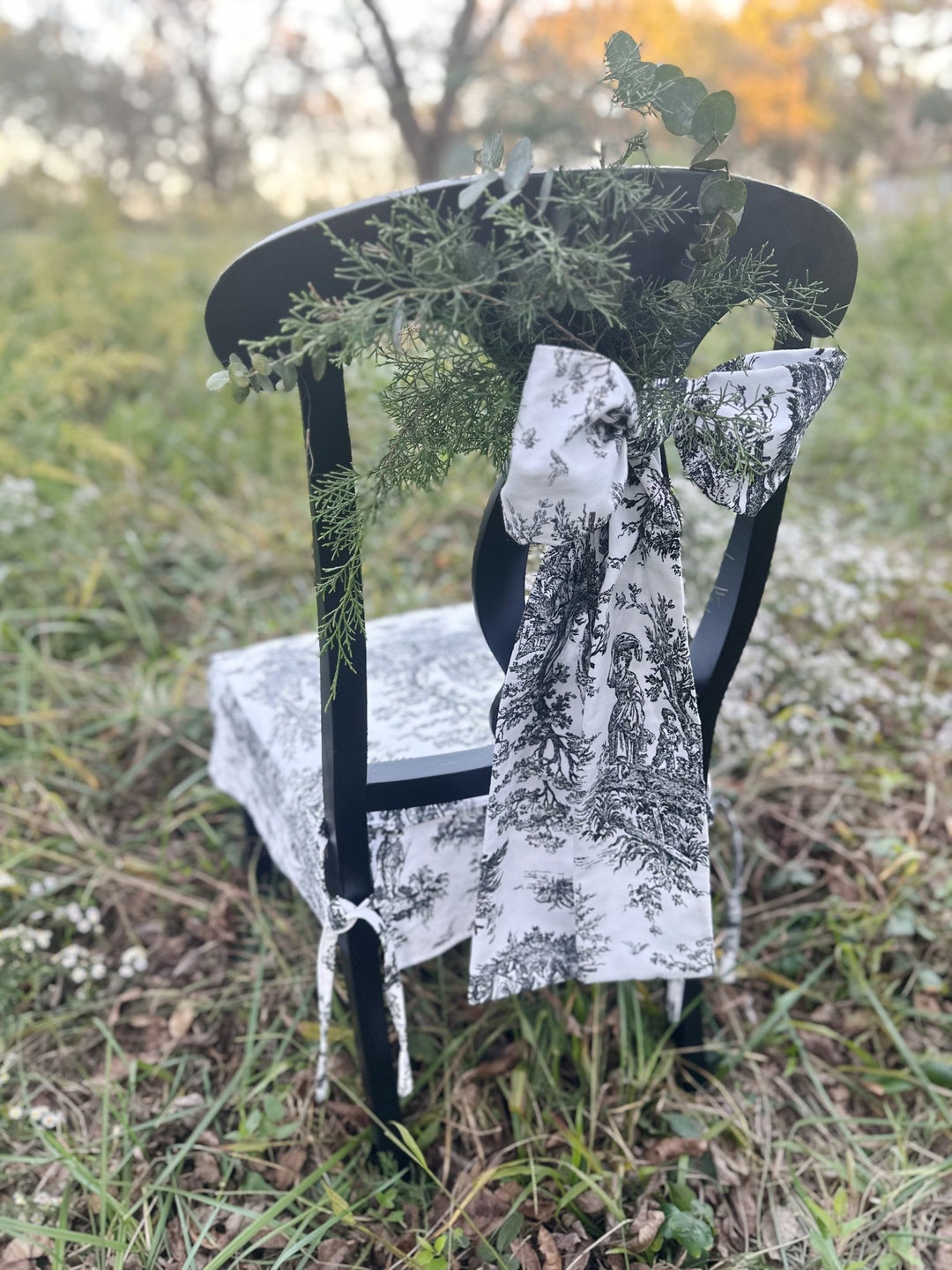 Black and white toile bow on the back of a dining chair, styled for Christmas dinner
